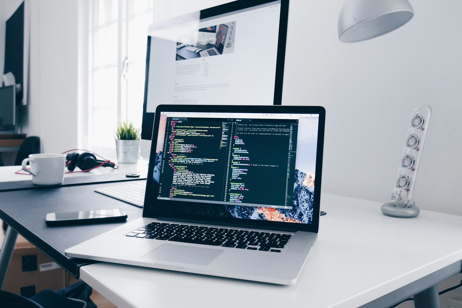 Code displayed across multiple monitors in an automated workflow.